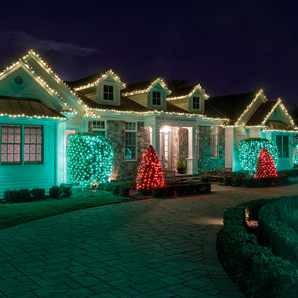 up close view of white home with holiday lighting