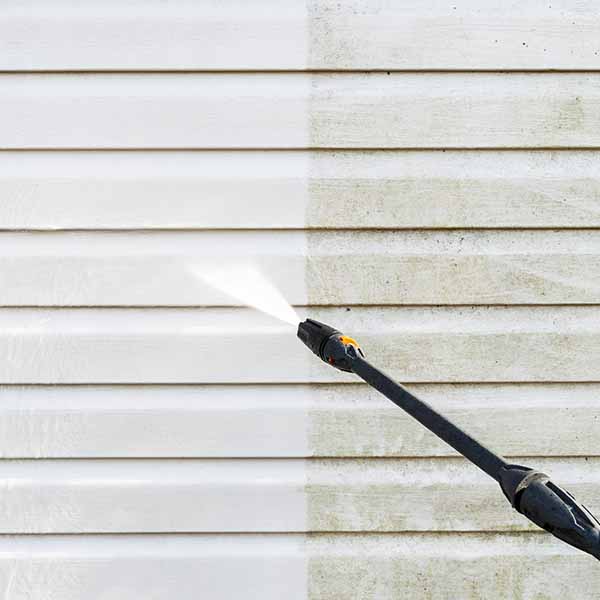 professional pressure washing siding of home before and after cleaning